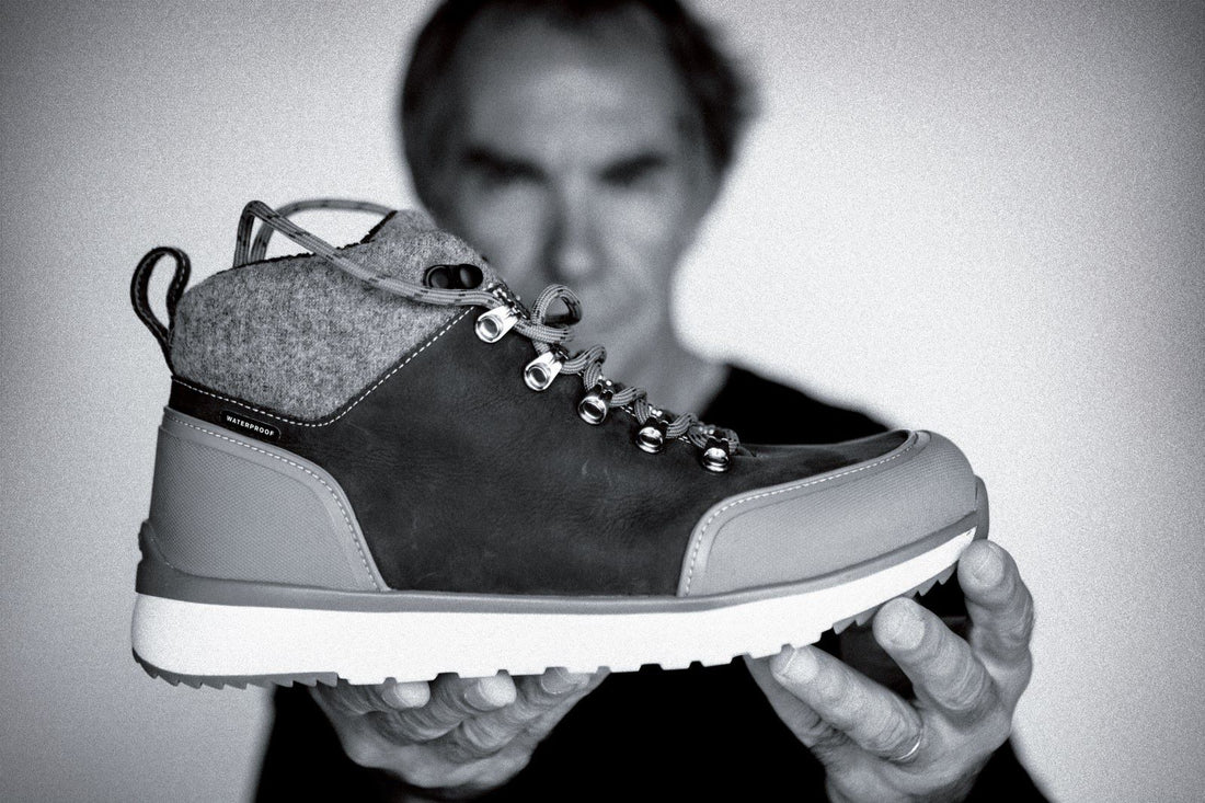 black and white image of a sneaker  boot held by innovator and business man, Jean-Luc Diard 
